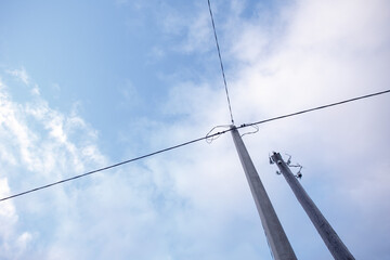 Obraz premium Wires and pillar against the sky.
