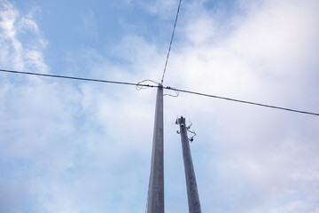 Wires and pillar against the sky.
