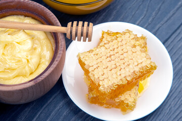 Fresh flower honey and honeycomb with spoons on a wooden background. Organic Vitamin Health Food