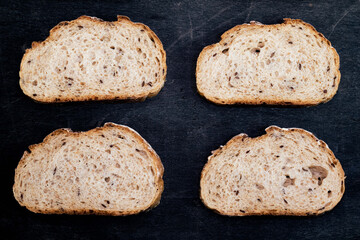 baguette bread sliced pattern isolated black wood background.