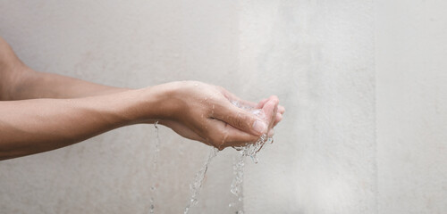 water flowing out of hand. water saving concept