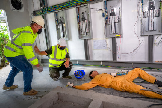 Electric worker suffered an electric shock accident unconscious. Safety team CPR for first aid Electric worker loses in electric shock accident at work on site. Accident in control room of factory.