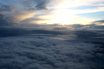 Fototapeta na wymiar View of the clouds from the airplane window. Dark clouds before the rain.