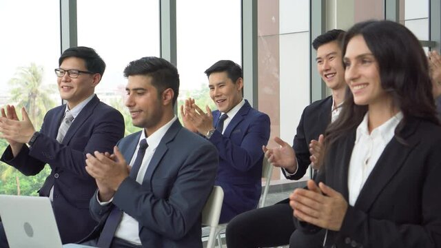 group of diverse business people audience applauding at business seminar . multi-ethnic clapping in meeting
