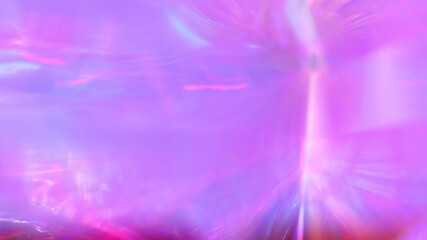 A holographic rainbow unicorn pastel purple pink teal colors abstract background. Optical crystal...
