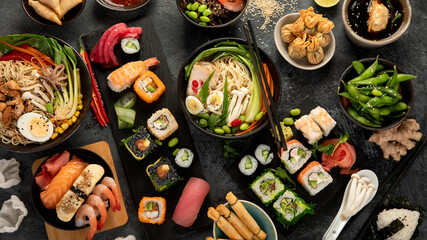Japanese dishes and snacks on gray background.