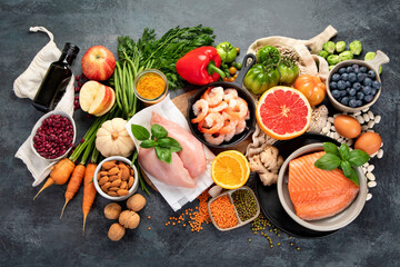 Healthy food assortment on dark background.