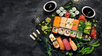 Sushi and roll set on dark background. Traditional food concept.