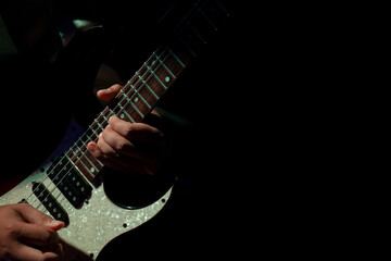 Fototapeta na wymiar Abstact, Hand musician playing on guitar, Black background