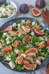 healthy autumn salad with figs, feta cheese and walnuts