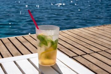cold drink standing on wooden floor by the beach