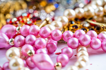 necklaces, earrings, bracelets, pearls, beads and various colored gemstones as a background