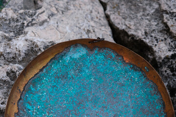 Obraz na płótnie Canvas The texture of copper with a blue-green color patina. Oxidized copper plate. Decorative effect. Stone background. Copy space. 
