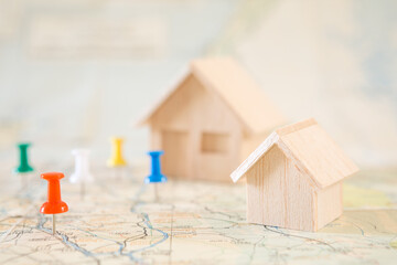 Selective focus of Red pin and house model on map background  for real estate concept