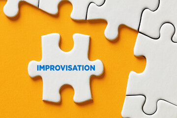 The word improvisation written on a puzzle piece apart form the assembled pieces. Improvising in business decisions - obrazy, fototapety, plakaty