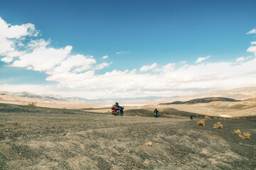 Obraz premium Motorcyclists ride in Death Valley, Ubehebe Crater viewpoint. Volcanic landscape, Extreme Sport, Active lifestyle, Adventure concept