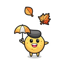 cartoon of the cute potato chip holding an umbrella in autumn