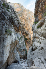 Stunning view of some tourists hiking in the Gorropu gorge during a sunny day. Gorropu is the...