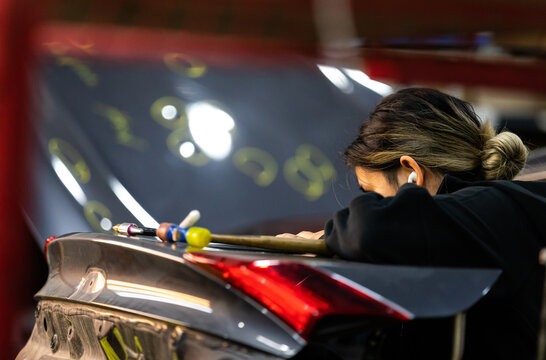 Woman fixing car