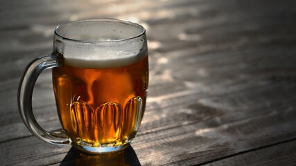 Refreshing fresh draft beer in a dewy glass. Good and honest Czech quality beer on a wooden table background.