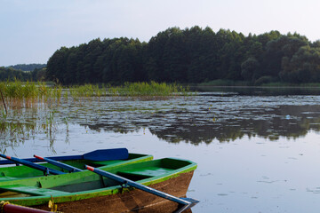 Obraz premium landscape with wooden boats on the river in Belarus