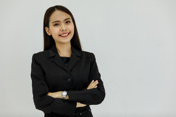Portrait studio shot of Asian young beautiful smart confident professional successful long hair businesswoman in black business formal suit stand smiling look at camera on white background