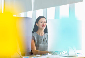 Background portrait of elegant caucasian business woman smile and enjoy typing happy message to communicate work achievement from marketing accountant on computer screen in corporation office