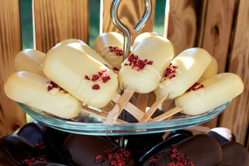 Cake pops in white and dark chocolate. Ice cream cake on a bag. Selective focus