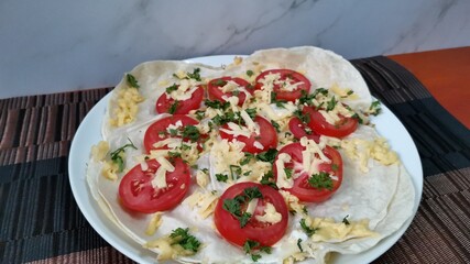 Tortillas with Melted Cheese and Tomato Slices and Parsley