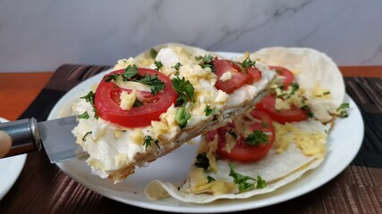 Tortillas Wrap Topped with tomato Slice and Melted Cheese