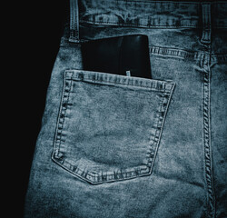 blue denim jeans with a leather wallet in back pocket