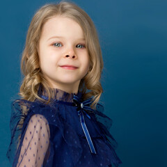 Portrait charming little girl in nice blue dress