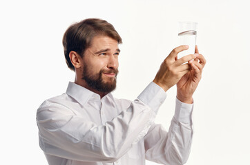 man in white shirt glass of water light background