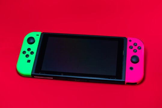 Fukuoka, Japan - september 18, 2021 : Nintendo Switch portable console isolated on red background
