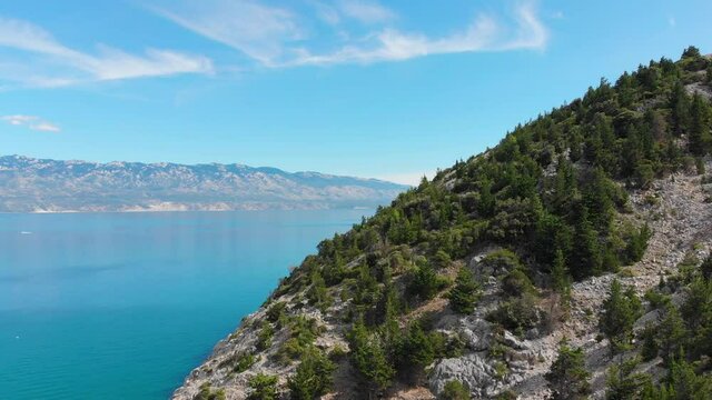 Forward Drone footage of Rab Island, Lopar Area in Croatia. Calm, sunny day . Epic landscape, Adriatic blue sea and mountains.