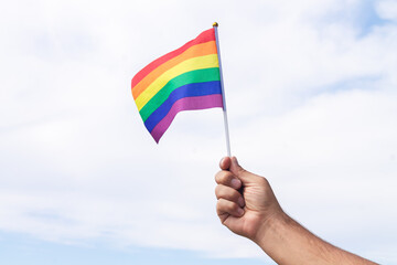Holding gay pride symbol rainbow flag