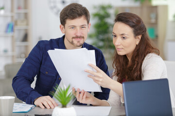 couple holding reading financial documents checking paying household bills