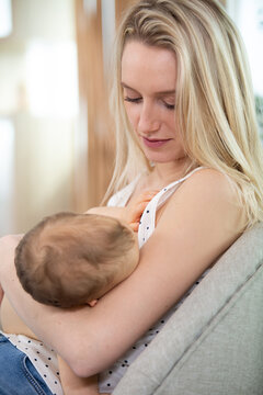 newborn baby being breastfed by mother