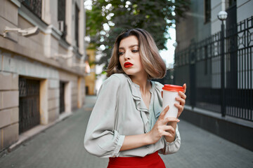 Fototapeta premium blonde outdoors red skirt hot drink outdoors in summer