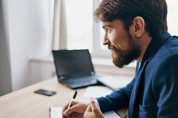 bearded man working for a laptop in the office emotions professional