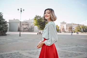 pretty woman in a red skirt city walk fun leisure lifestyle