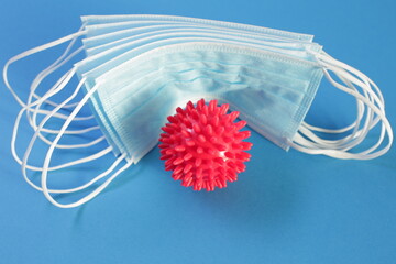 Viral Coronavirus Bacteria And Protective Medical Disposable Masks On A Blue Background. Concept Of...