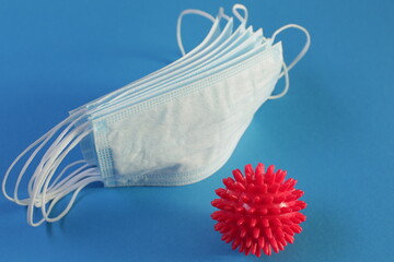 Viral Coronavirus Bacteria And Protective Medical Disposable Masks On A Blue Background. Concept Of...