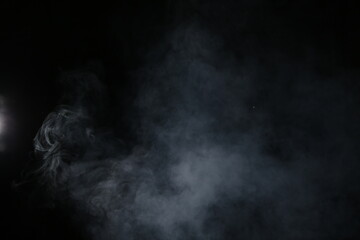 Obraz premium Artificial magic smoke isolated on dark background