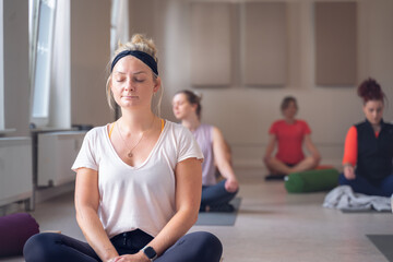 Group of young people have meditation on Yoga class.