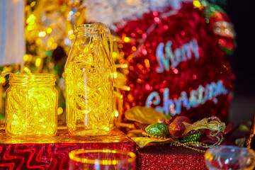 christmas decoration with warm light in bottle and face mask hanging on christmast  craft pine tree