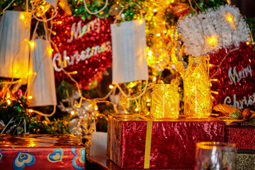 christmas decoration with warm light in bottle and face mask hanging on christmast  craft pine tree
