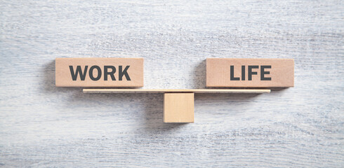 Work and Life balance on white wooden background.