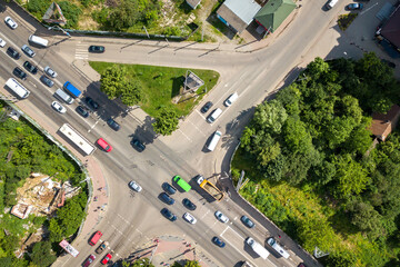 Fototapeta na wymiar Top down aerial view of busy street intersection with moving cars traffic.