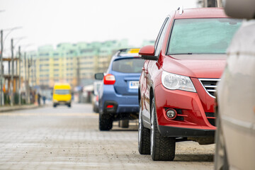 Cars parked in a row on a city street side.